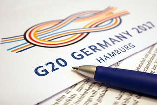 View of documents with the logo of the German G20 presidency