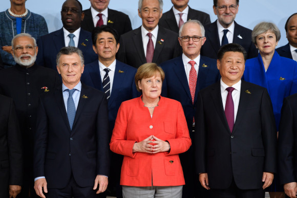 Chancellor Angela Merkel during the family photo surrounded by the G20 heads of state and government and other G20 participants.