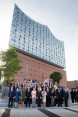 Group photo of the G20 participants and their partners in front of the Elbphilharmonie.
