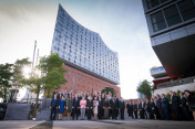 Group photo of the G20 participants and their partners in front of the Elbphilharmonie.