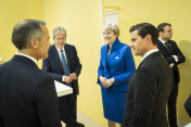 Theresa May, Prime Minister of the United Kingdom, in conversation with Mark Carney, Chairman of the Financial Stability Board (FSB), and other participants before the G20 summit’s retreat on counter-terrorism.