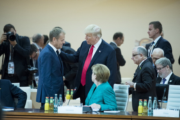 Donald Tusk, President of the European Council, and US President Donald Trump in conversation before the third working session (front: Federal Chancellor Angela Merkel). 