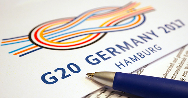 View of documents with the logo of the German G20 presidency