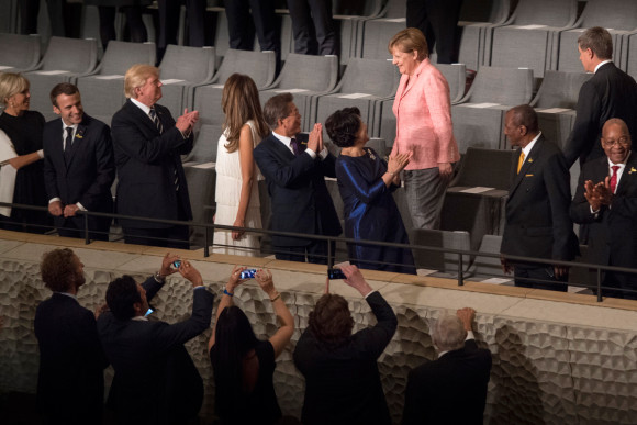 Chancellor Angela Merkel and her husband Joachim Sauer arrive for the concert in the Elbphilharmonie Concert Hall during the G20 Summit. 