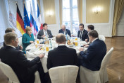 Chancellor Angela Merkel at the trilateral breakfast in the Hotel Atlantic with French President Emmanuel Macron and Russia's President Vladimir Putin.