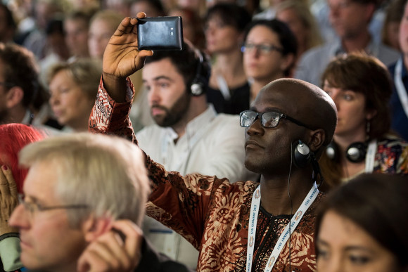 One summit participant films the panel discussion with his mobile.